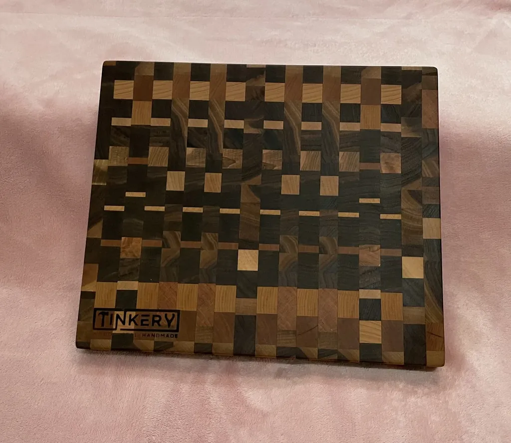 A finished end-grain cutting board with the Tinkery mark