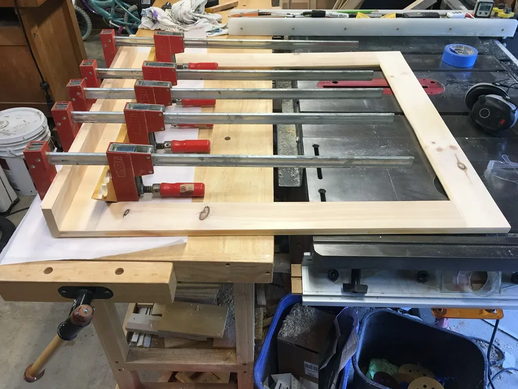 A large frame glue-up clamped across the workbench