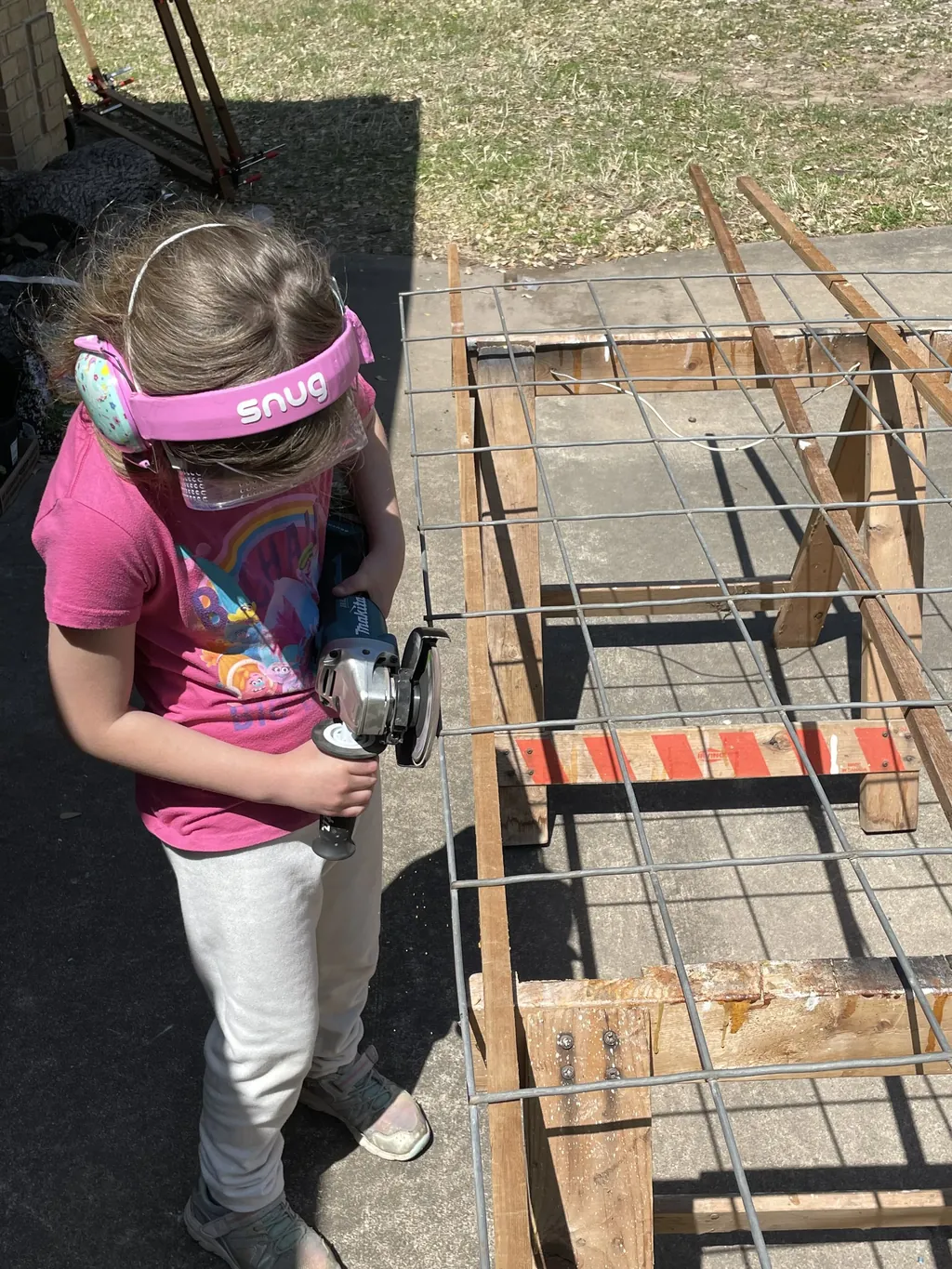 A young maker working on an outdoor build project